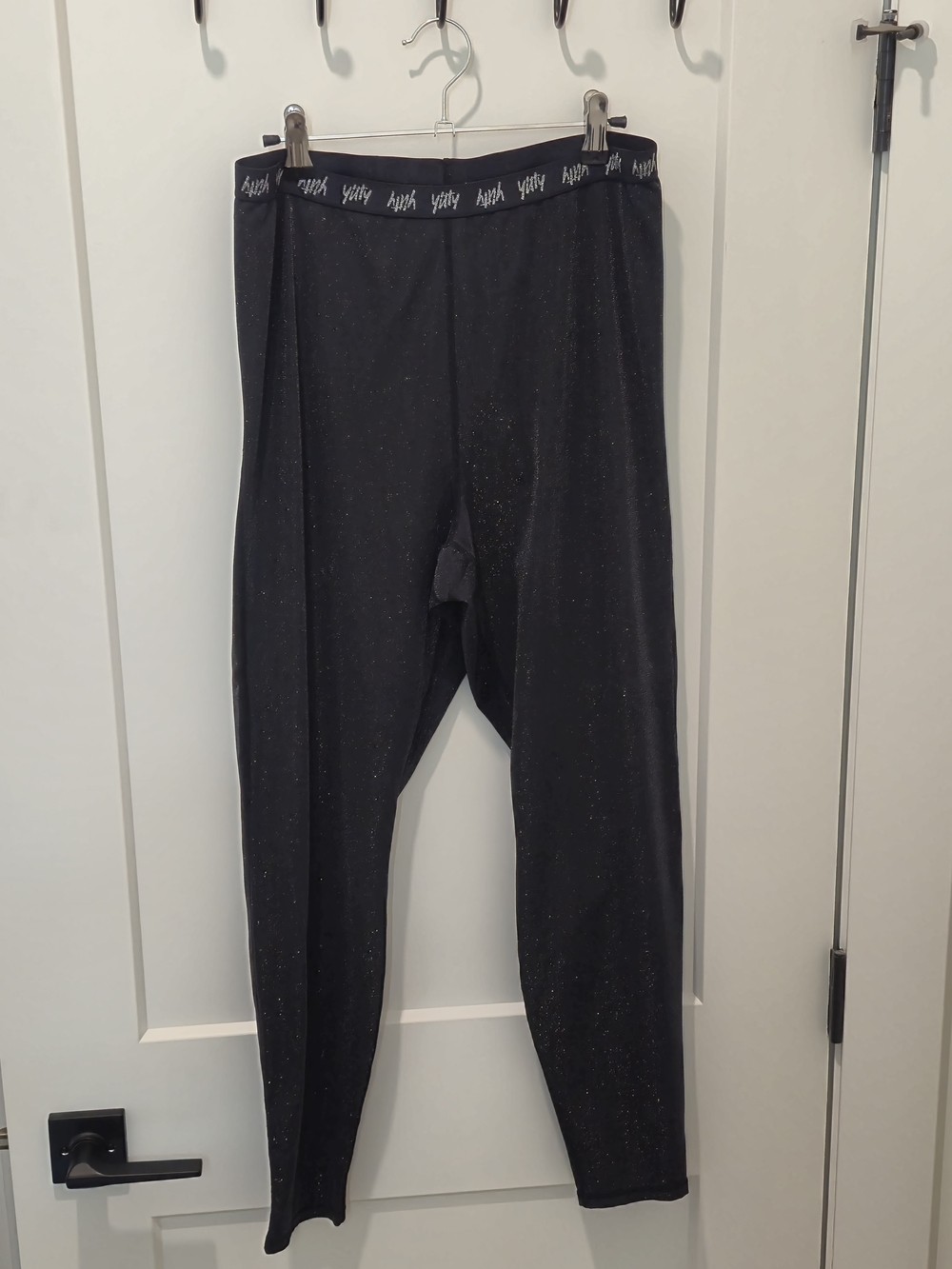 Yitty Spotlight Shaping Ruched Leggings in a black sparkle/shimmer finish.